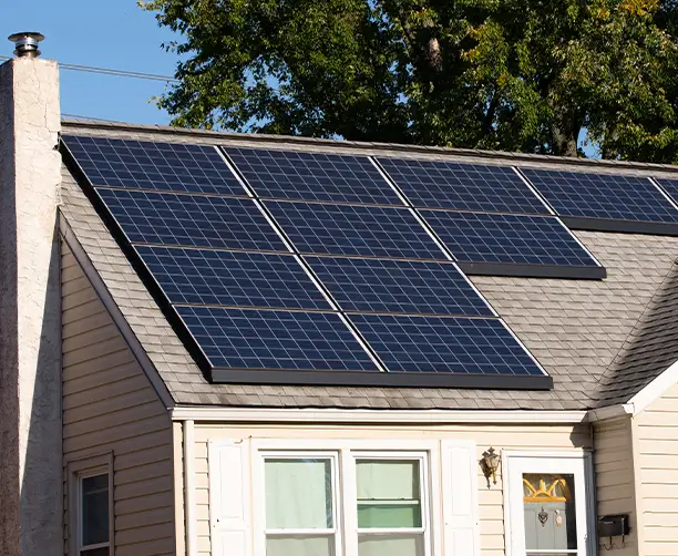 House With Solar Panels On Asphalt Roof